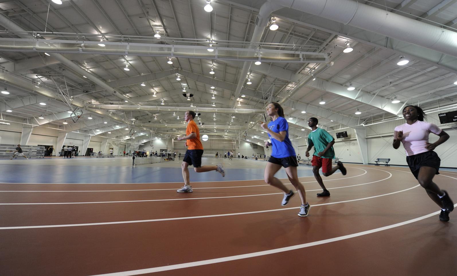 VinU students running around an indoor track.